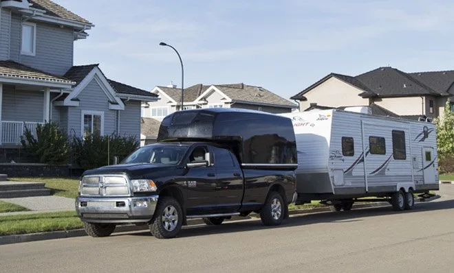 A truck and attached recreational trailer pictured in the County’s RV-parking guidance.