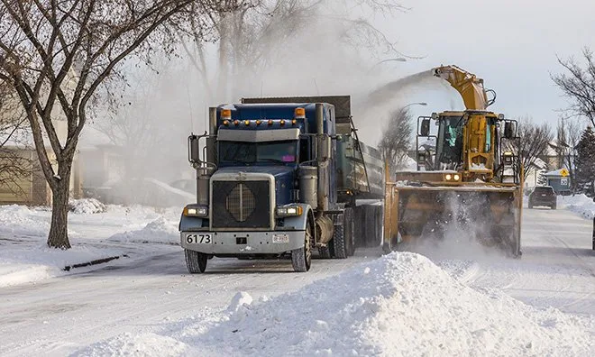 Strathcona County snow-clearing crews working on an urban street.